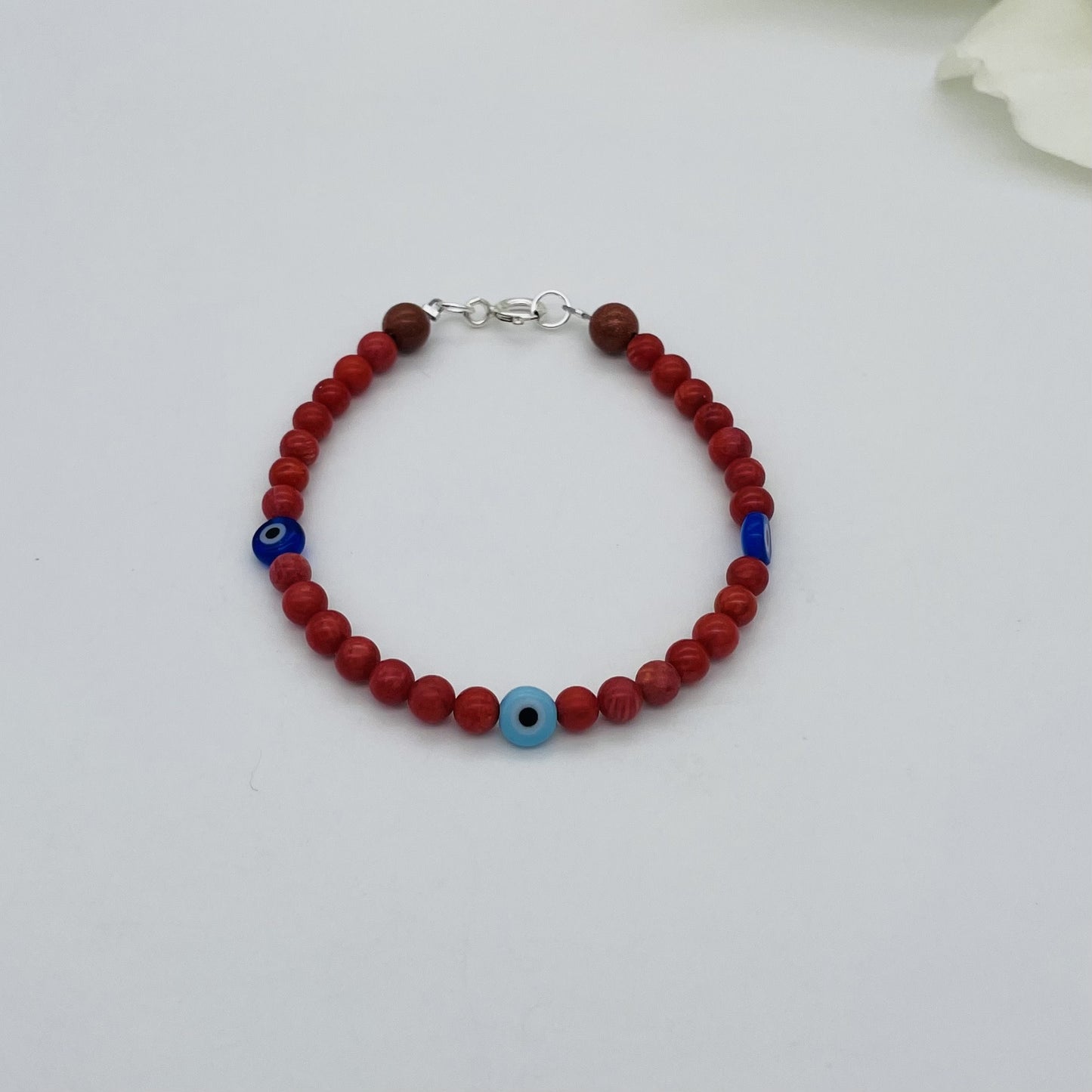 ST1762BL Red Dyed Bamboo Coral Blue Eyes Bracelet  7"